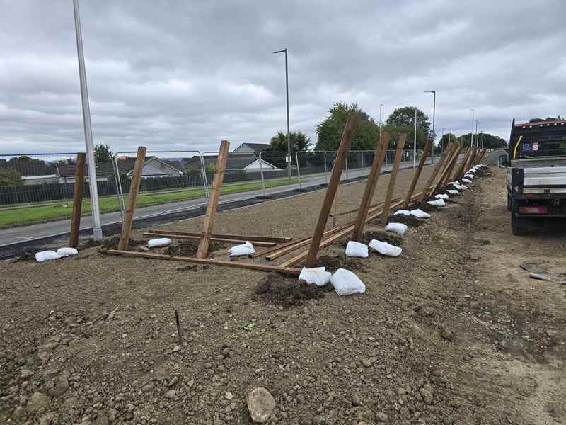 Timber posts going in with post-mix on a Bo'ness development site