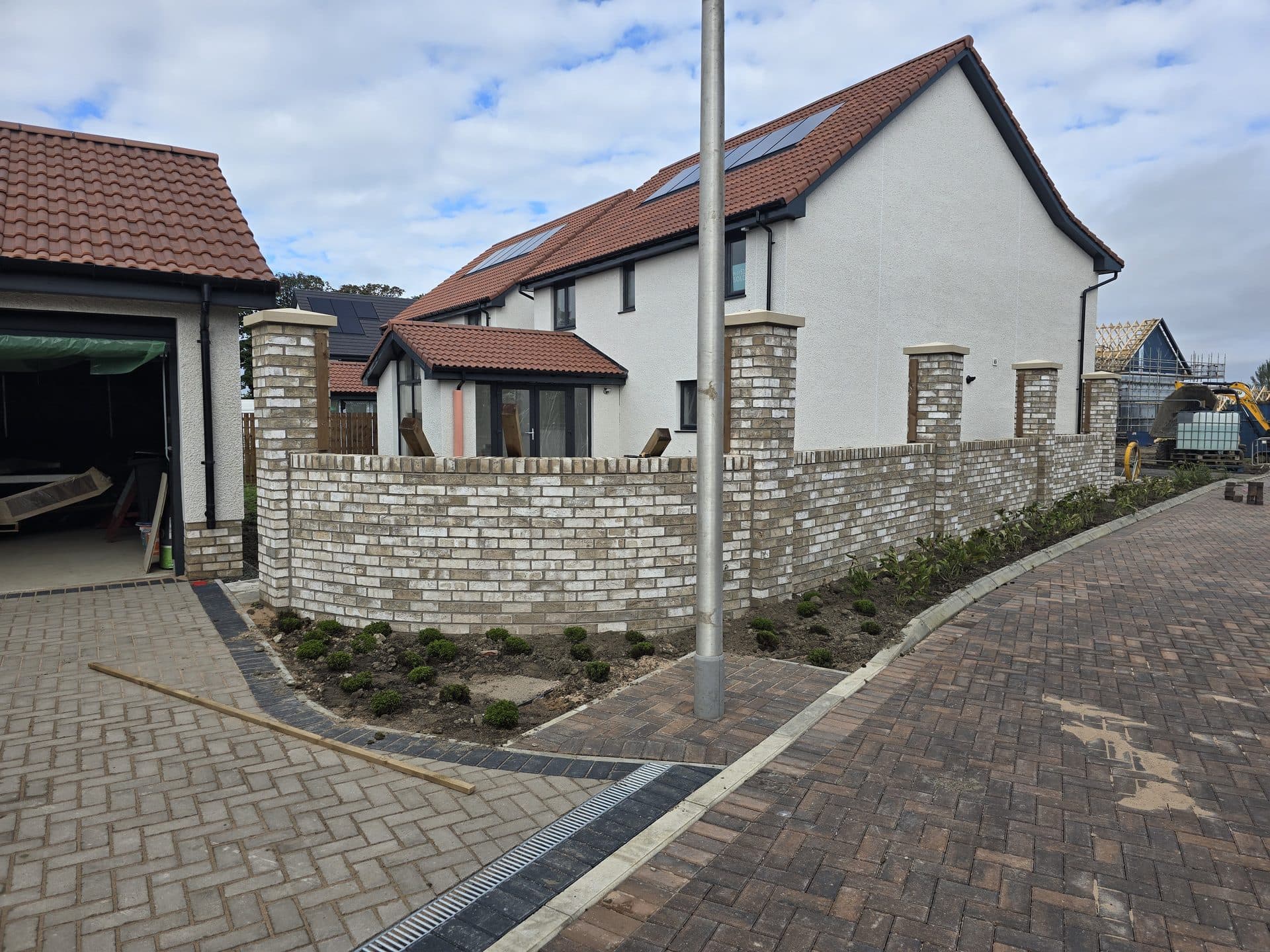 Existing brick walls and pillars on an East Calder new-build plot, before timber