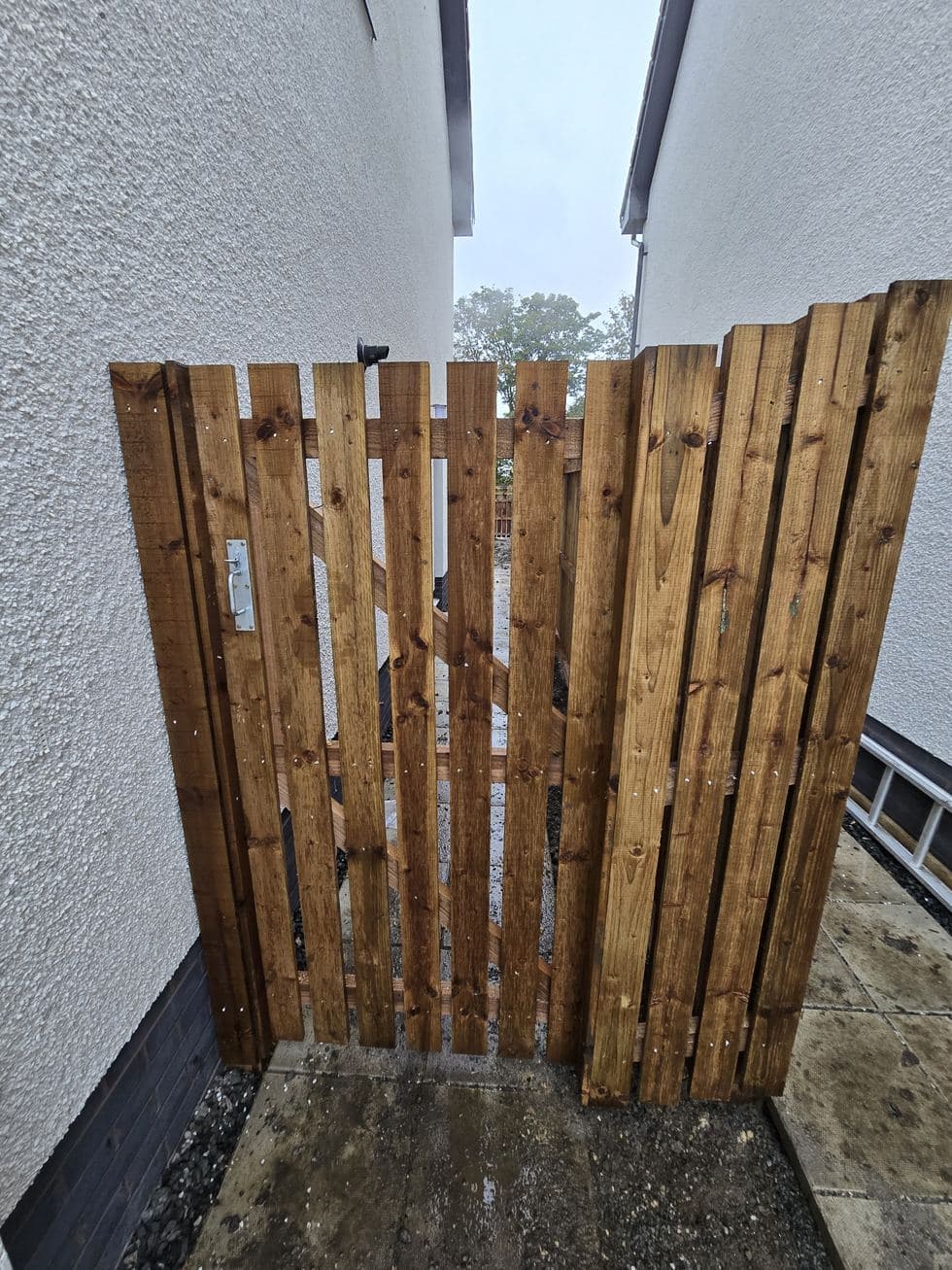 Timber side gate between two houses in East Calder